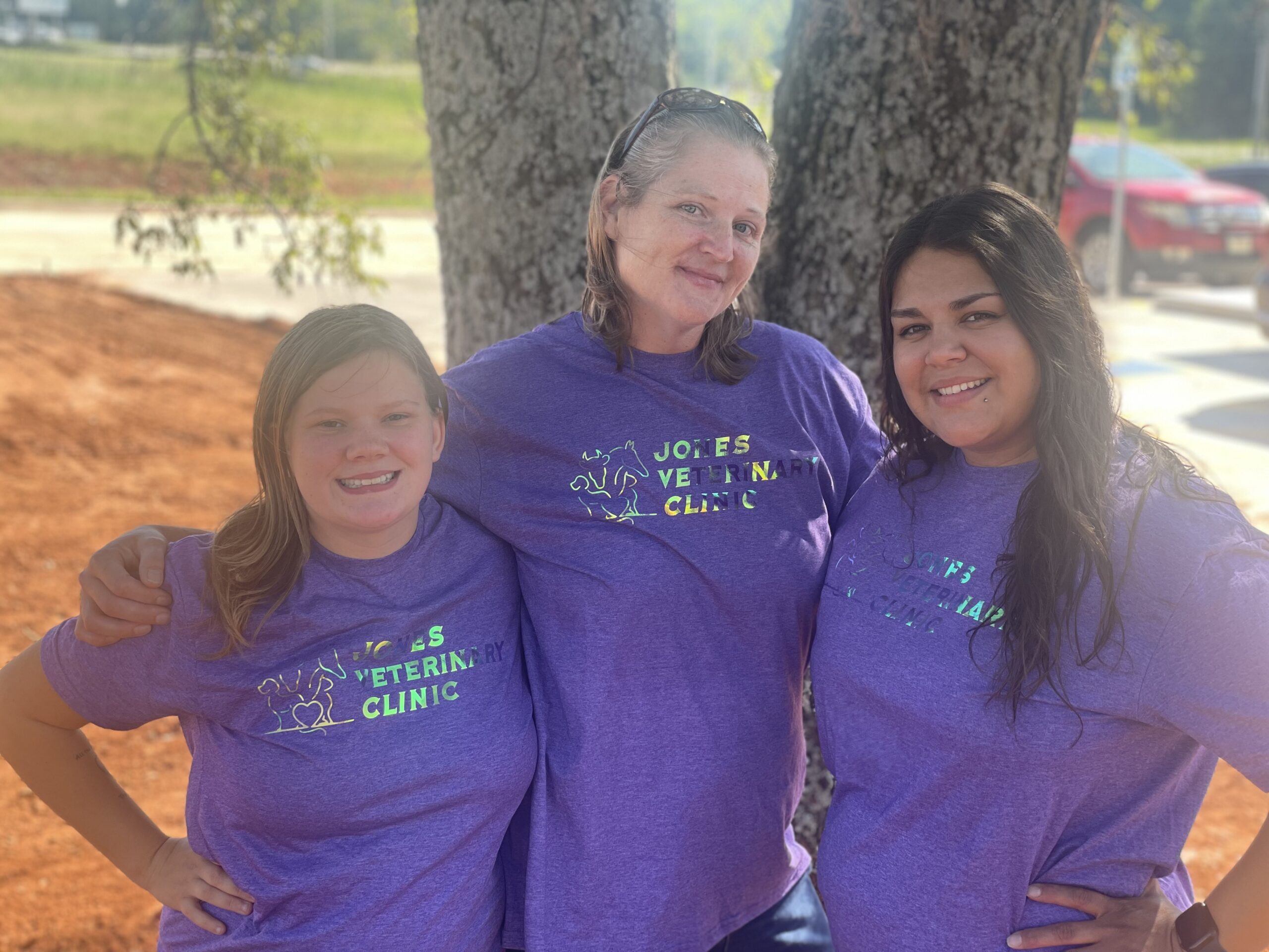 Veterinary Staff and support for Jones Vet Clinic. Three women posing for a picture under a tree.
