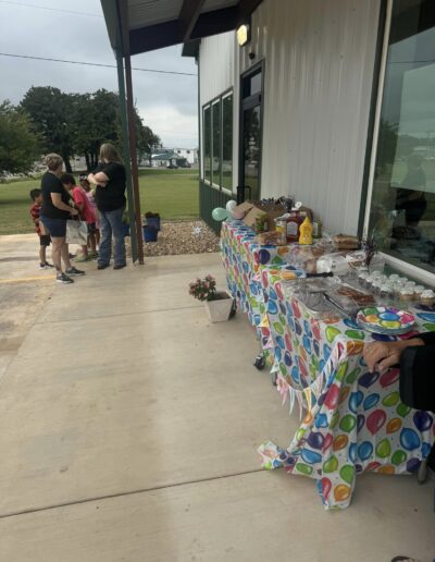 outside the clinic snacks, drinks, and balloons line the sidewalk