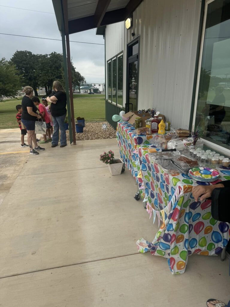 outside the clinic snacks, drinks, and balloons line the sidewalk