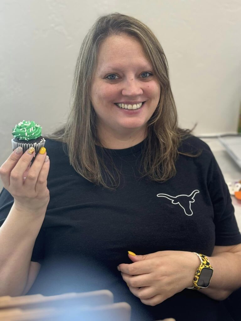 Vet Staff holds a cupcake